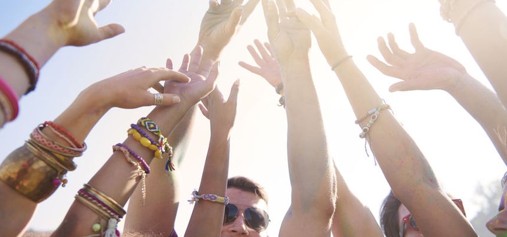Image of festival goers with hands raised